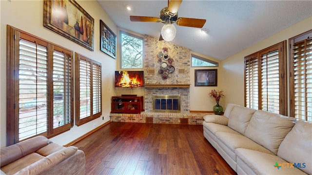 living room featuring a fireplace, dark hardwood / wood-style flooring, a wealth of natural light, and ceiling fan