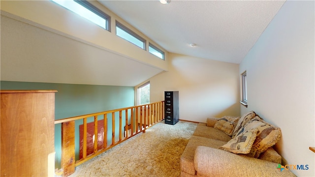 interior space with carpet flooring, a healthy amount of sunlight, and lofted ceiling