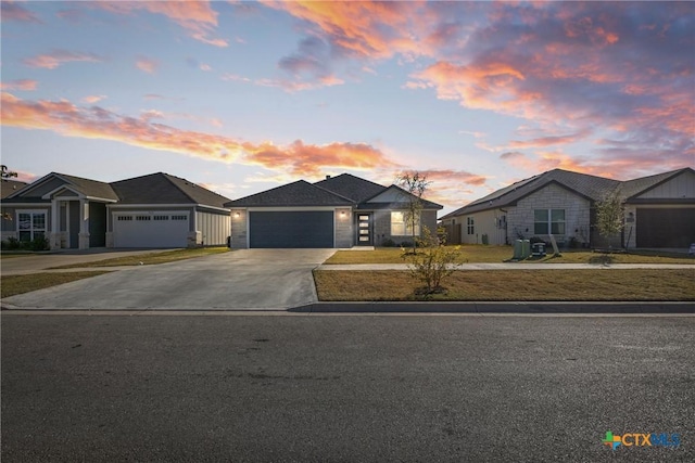 1519 Curlew Ln, Temple, TX 76502 - view of front facade featuring driveway, a garage, a residential view, and stone siding