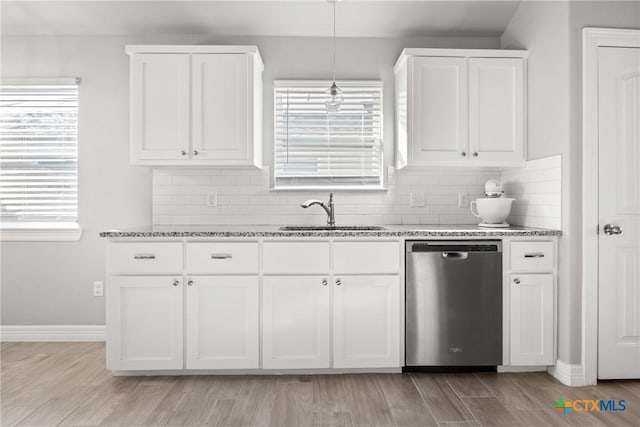 1519 Curlew Ln, Temple, TX 76502 - kitchen featuring dishwasher, a sink, light stone countertops, backsplash, and white cabinets