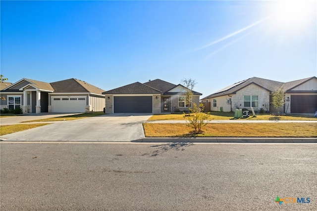 ranch-style home with a garage and a front yard