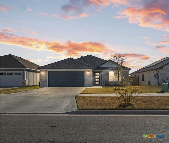 view of front facade with a garage and a yard