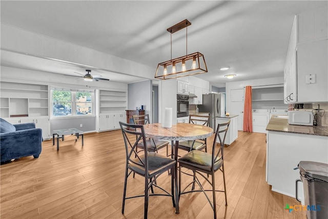 dining space featuring light wood-style floors, ceiling fan, and built in shelves