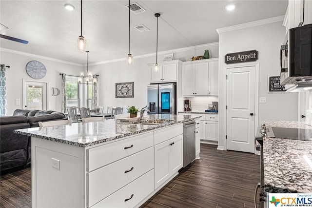 kitchen featuring light stone counters, white cabinets, a kitchen island with sink, dark hardwood / wood-style floors, and appliances with stainless steel finishes