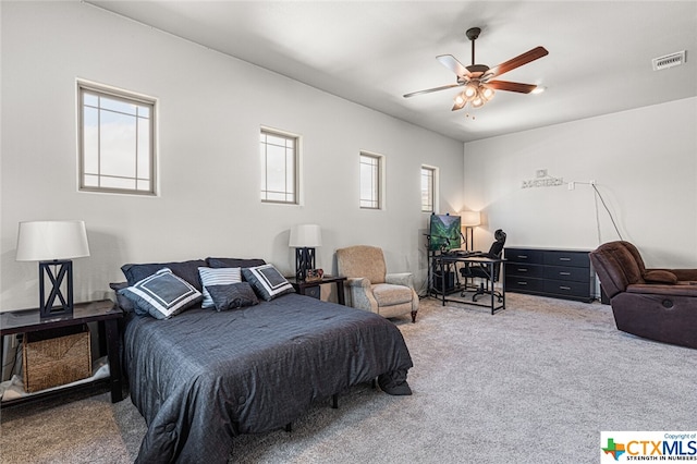 bedroom featuring carpet, multiple windows, and ceiling fan