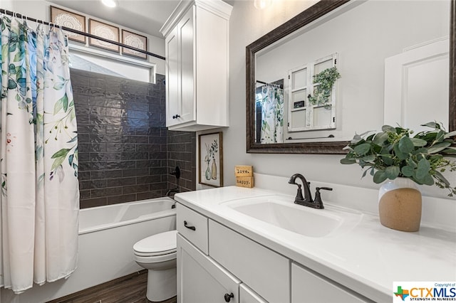 full bathroom featuring hardwood / wood-style flooring, vanity, shower / bath combo, and toilet