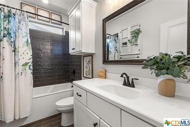 bathroom featuring toilet, shower / bath combination with curtain, vanity, and wood finished floors