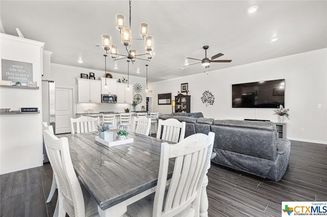 dining area with dark wood-style floors, ornamental molding, a chandelier, a ceiling fan, and recessed lighting
