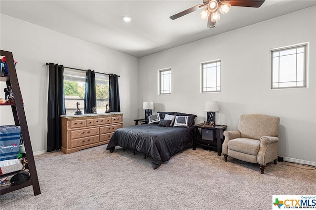 bedroom with light carpet, baseboards, and ceiling fan