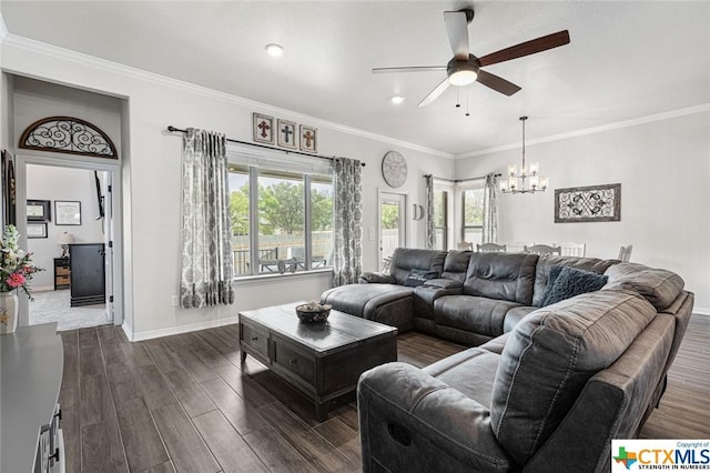 living room featuring a ceiling fan, dark wood-style flooring, a chandelier, baseboards, and crown molding