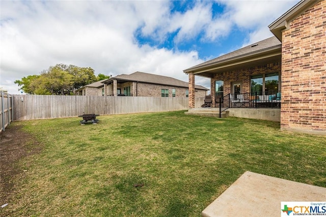 view of yard featuring a patio and a fire pit