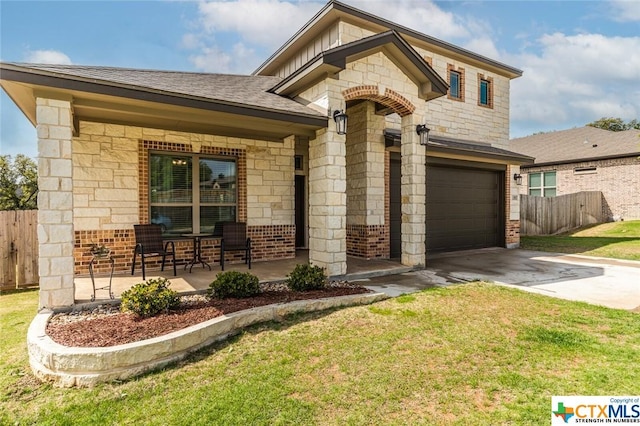 view of front of house featuring driveway, brick siding, an attached garage, and covered porch