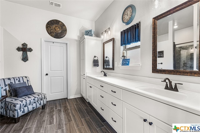 bathroom with hardwood / wood-style floors and vanity