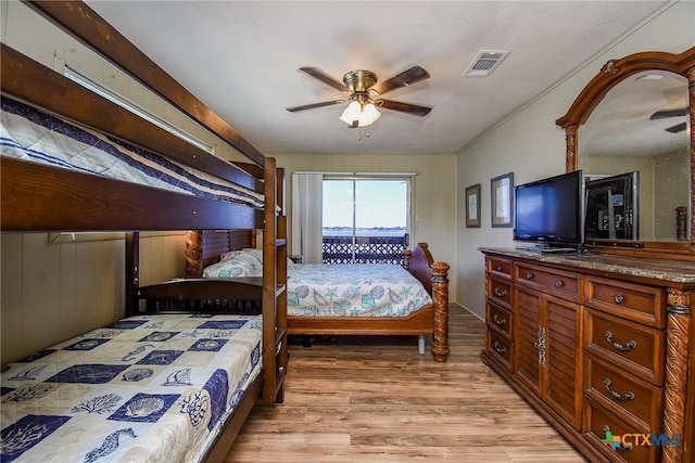 bedroom featuring light wood-style flooring, visible vents, and ceiling fan