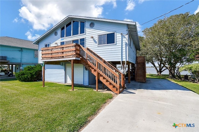 view of front facade featuring an attached garage, stairs, concrete driveway, and a front yard