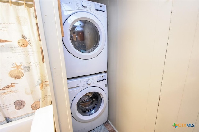 laundry area with stacked washer / dryer