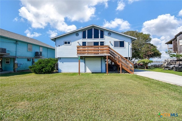 exterior space featuring driveway, a garage, stairway, and a yard