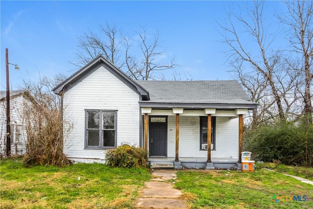 318 Durr St, Marlin, TX 76661 - view of front of home featuring covered porch, a front yard, and roof with shingles