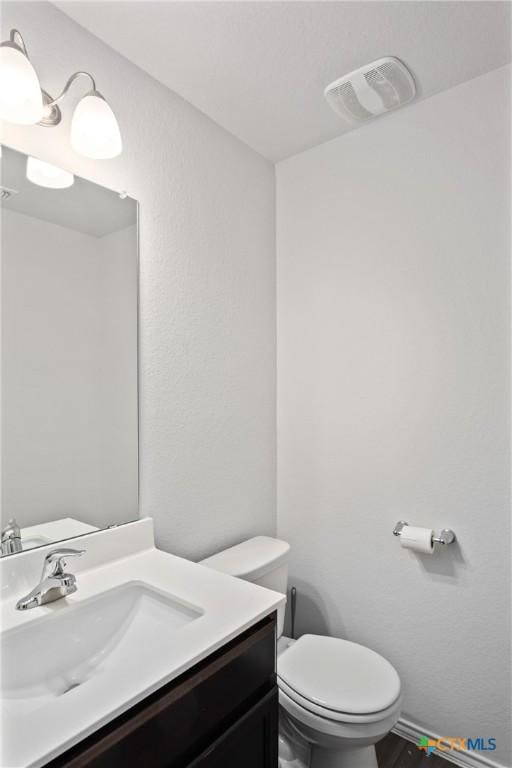 bathroom with toilet and vanity