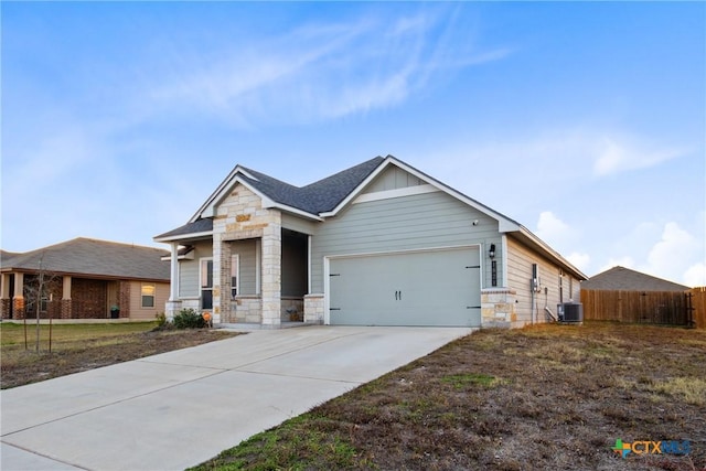 view of front of property featuring a front yard, a garage, and cooling unit