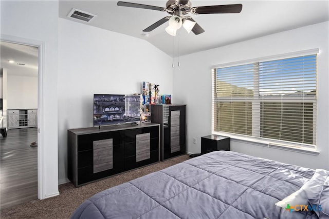 bedroom with vaulted ceiling, ceiling fan, and carpet floors