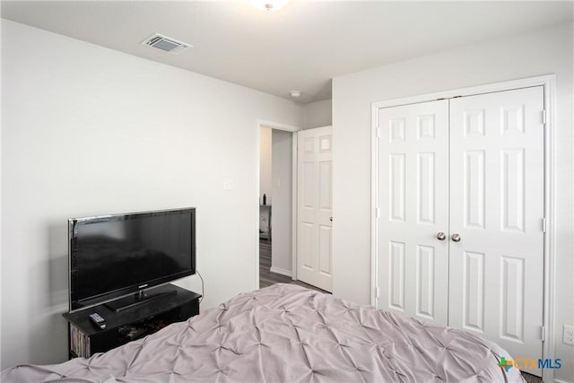 bedroom featuring hardwood / wood-style flooring and a closet