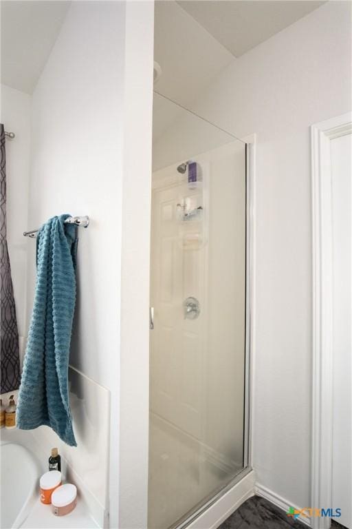 bathroom with a shower with shower door