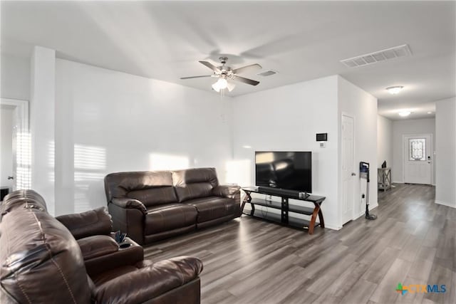 living room with ceiling fan, wood-type flooring, and plenty of natural light