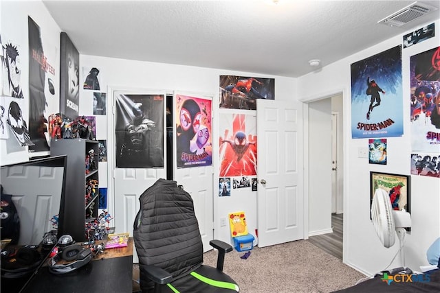 game room with carpet and a textured ceiling