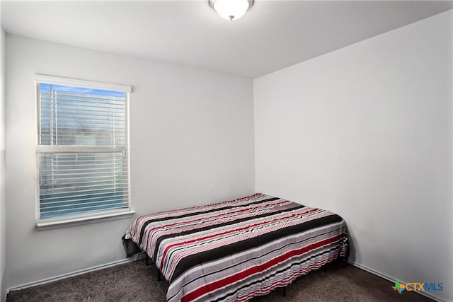 bedroom featuring dark carpet