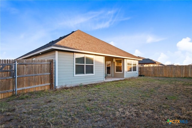 back of house featuring a patio area and a yard