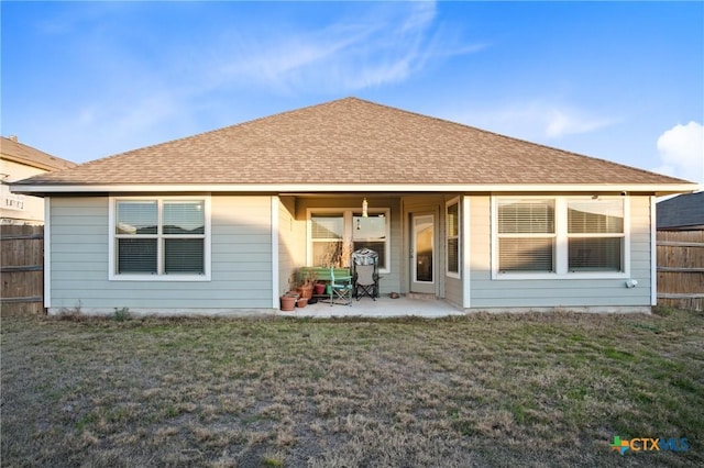 back of property with a patio and a yard