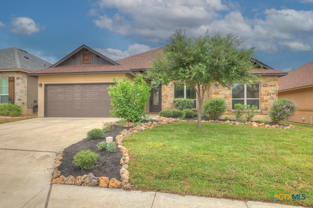 view of front of property with a garage and a front lawn