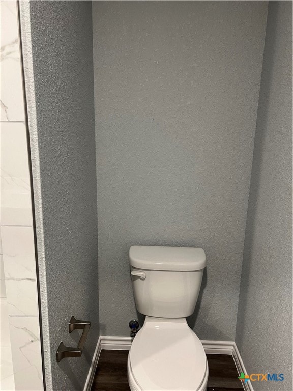 bathroom featuring hardwood / wood-style floors and toilet