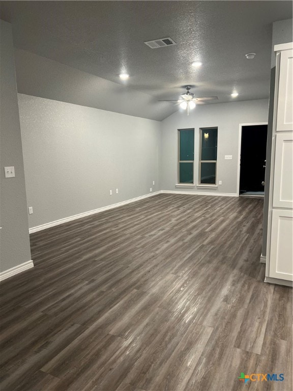 empty room featuring ceiling fan, dark hardwood / wood-style flooring, and a textured ceiling