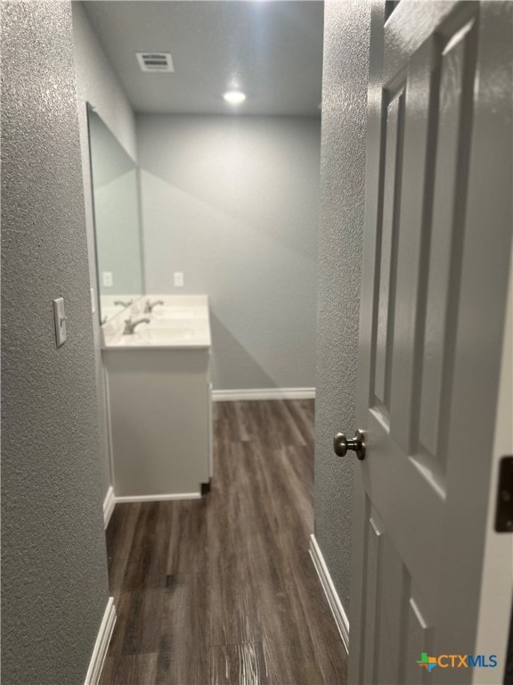 bathroom with hardwood / wood-style floors and vanity