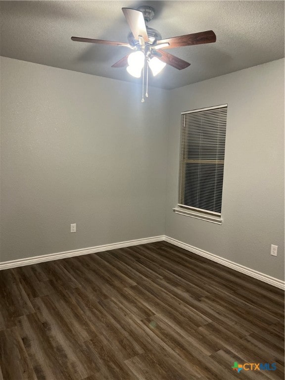 spare room featuring ceiling fan, dark hardwood / wood-style flooring, and a textured ceiling