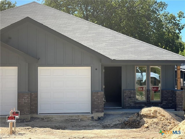 doorway to property with a garage