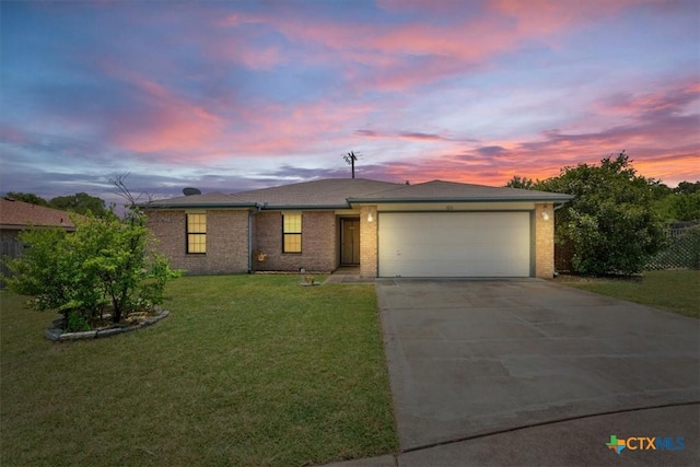 ranch-style house featuring a lawn and a garage