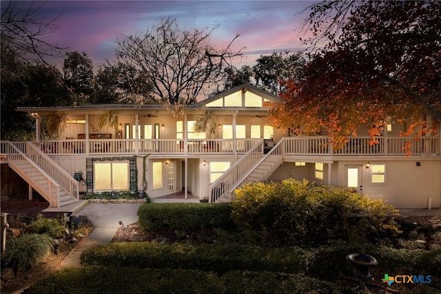 back house at dusk with a patio area