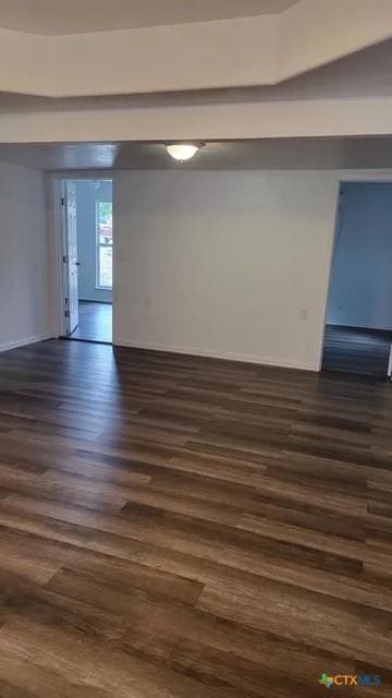 empty room featuring dark wood-type flooring