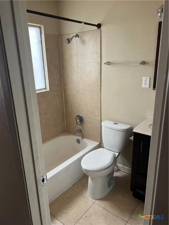 full bathroom featuring tile patterned floors, tiled shower / bath combo, toilet, and vanity