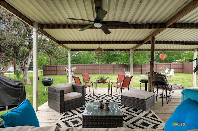 view of patio with an outdoor living space, a ceiling fan, a fenced backyard, area for grilling, and a wooden deck