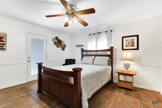 bedroom with wood finished floors, a ceiling fan, and baseboards