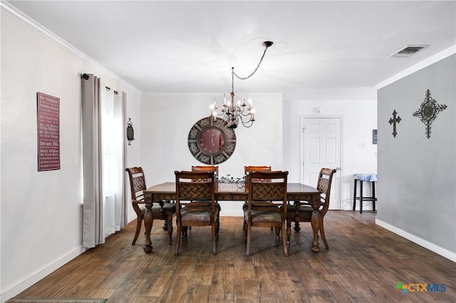 dining area featuring an inviting chandelier, crown molding, dark wood-style flooring, and visible vents
