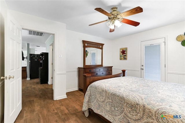 bedroom with freestanding refrigerator, visible vents, ceiling fan, and dark wood-style flooring