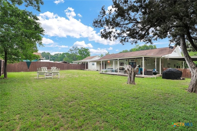 rear view of house featuring a fenced backyard, a yard, and a patio