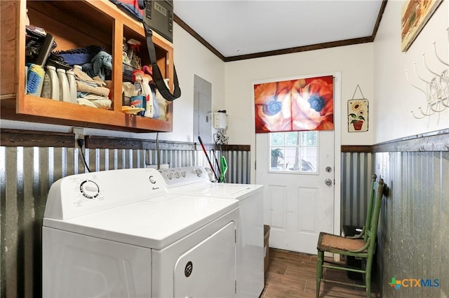 laundry room featuring a wainscoted wall, washing machine and dryer, ornamental molding, dark wood-type flooring, and laundry area
