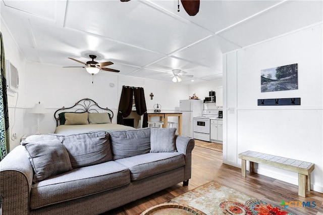 living room with ceiling fan and light wood-type flooring