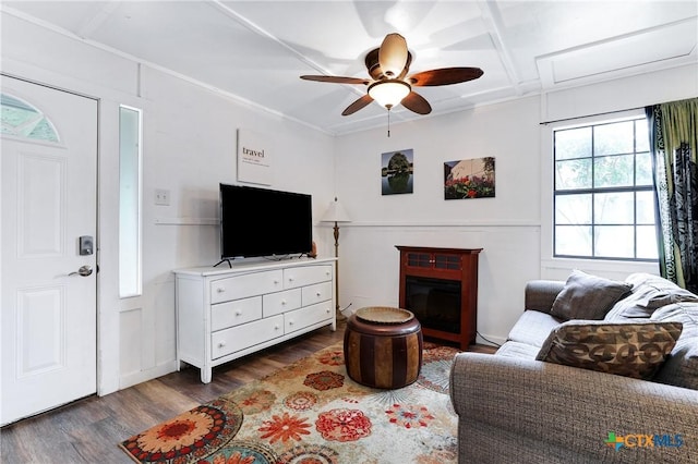 living area featuring dark wood-style flooring, a ceiling fan, and a glass covered fireplace